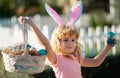 Excited child with easter basket. Easter bunny child boy with cute face. Kids hunting easter eggs. Happy easter holiday.