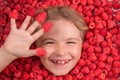 Excited child face with raspberries. Fresh raw raspberry near kids face. Raspberri macro. Top view of collection Royalty Free Stock Photo