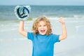 Excited child funny face. Excited child with thumbs up on sea summer beach. Expressive emotional face. Funny expressive