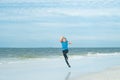 Excited child running in the sea. Cute kid run on summer sea. Funny expressive emotional boy running on summer beach