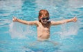 Excited child in sunglasses in pool in summer day. Child in summer swimming pool splashing in water having fun leisure Royalty Free Stock Photo