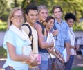 Excited about college. Portrait of a group of students standing in a line on campus. Royalty Free Stock Photo