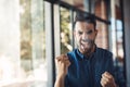 Excited and confident business man cheering in his office and showing hand gesture. Successful and happy male Royalty Free Stock Photo