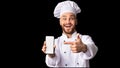 Cook Man Showing Phone Empty Screen Standing On Black Background Royalty Free Stock Photo