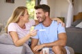 Excited Couple In Bedroom At Home Celebrating Positive Pregnancy Test Result Royalty Free Stock Photo