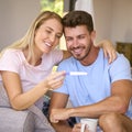 Excited Couple In Bedroom At Home Celebrating Positive Pregnancy Test Result Royalty Free Stock Photo