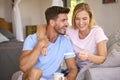 Excited Couple In Bedroom At Home Celebrating Positive Pregnancy Test Result Royalty Free Stock Photo