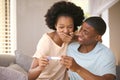 Excited Couple In Bedroom At Home Celebrating Positive Pregnancy Test Result Royalty Free Stock Photo