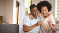 Excited Couple In Bedroom At Home Celebrating Positive Pregnancy Test Result Royalty Free Stock Photo