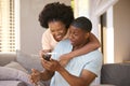 Excited Couple In Bedroom At Home Celebrating Positive Pregnancy Test Result Royalty Free Stock Photo