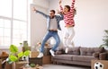 Excited couple celebrating relocation in new apartment Royalty Free Stock Photo