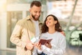 Excited couple checking their passports and boarding passes in airport terminal Royalty Free Stock Photo