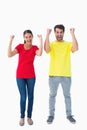 Excited couple cheering in red and yellow tshirts