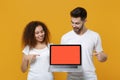 Excited couple friends european guy african american girl in white t-shirts isolated on yellow background. People Royalty Free Stock Photo