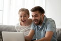 Excited couple looking at laptop amazed by online winning bid Royalty Free Stock Photo