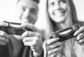 Excited couple playing video games at home - Happy young people having fun with new online trends technologies Royalty Free Stock Photo