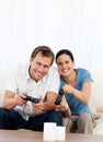 Excited couple playing video games together Royalty Free Stock Photo