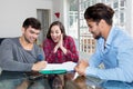 Excited couple signing contract for own house Royalty Free Stock Photo