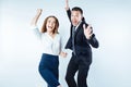Excited coworkers jumping high while cannot keep their emotions inside