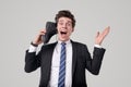 Excited crazy worker talking on boot as on smartphone Royalty Free Stock Photo