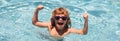 Excited cute little boy in sunglasses in pool in sunny day. Child relax in summer swimming pool. Banner for header, copy Royalty Free Stock Photo