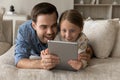 Excited daddy and surprised gen Z daughter kid reading book