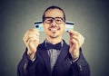 Excited debt free business man in glasses holding a credit card cut in two pieces Royalty Free Stock Photo