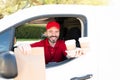 Male worker giving a bag of fast food and coffee to a customer Royalty Free Stock Photo