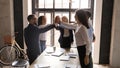 Excited diverse business people giving high five at corporate meeting Royalty Free Stock Photo