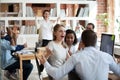 Excited diverse business team employees screaming celebrating good news success