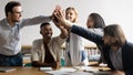 Excited diverse business team giving high five at meeting Royalty Free Stock Photo