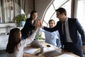 Excited diverse colleagues giving high five, showing unity at meeting Royalty Free Stock Photo