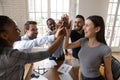 Excited diverse employee give high five at office meeting Royalty Free Stock Photo