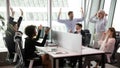 Excited diverse employees celebrate shared work success Royalty Free Stock Photo