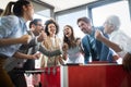 Excited diverse employees enjoying funny activity at work break, creative friendly workers play game Royalty Free Stock Photo