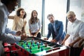 Excited diverse employees enjoying funny activity at work break, creative friendly workers play game Royalty Free Stock Photo