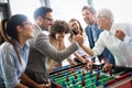 Excited diverse employees enjoying funny activity at work break, creative friendly workers play game Royalty Free Stock Photo