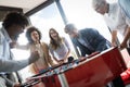 Excited diverse employees enjoying funny activity at work break, creative friendly workers play game Royalty Free Stock Photo