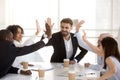 Excited diverse employees give high five celebrating success Royalty Free Stock Photo