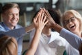 Excited diverse employees give high five motivated for success Royalty Free Stock Photo