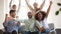 Excited diverse football fans celebrating win, screaming with joy