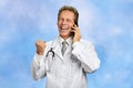 Excited doctor talking on mobile phone.