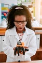 Excited, education and girl with a robot, science class and innovation with progress, creativity and development. Female