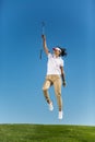 Woman with golf driver jumping up Royalty Free Stock Photo