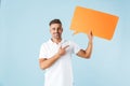 Excited happy adult man posing  over blue wall background holding passport and pineapple Royalty Free Stock Photo