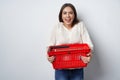 Excited emotional woman holding empty shopping basket