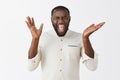 Excited emotive African American guy with beard in white shirt screaming out loud from happiness and amazement Royalty Free Stock Photo