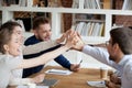 Excited employees give high five celebrating shared success Royalty Free Stock Photo