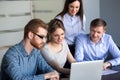 Excited employees looking at laptop observing growing statistics Royalty Free Stock Photo