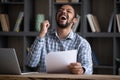 Excited euphoric Black student guy receiving admission letter from school Royalty Free Stock Photo